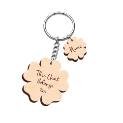Personalised wooden flower keyring with "This Auntie belongs to" engraving and two small flower name charms for Emily and Chloe.