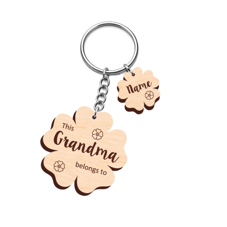 Personalised ornate wooden flower keyring with decorative engraving and floral motifs for family names