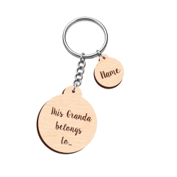 Personalised wooden round keyring engraved with This Granda belongs to and a small name charm