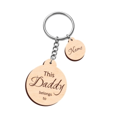 Modern personalised wooden round keyring with bold elegant script and a small name charm.