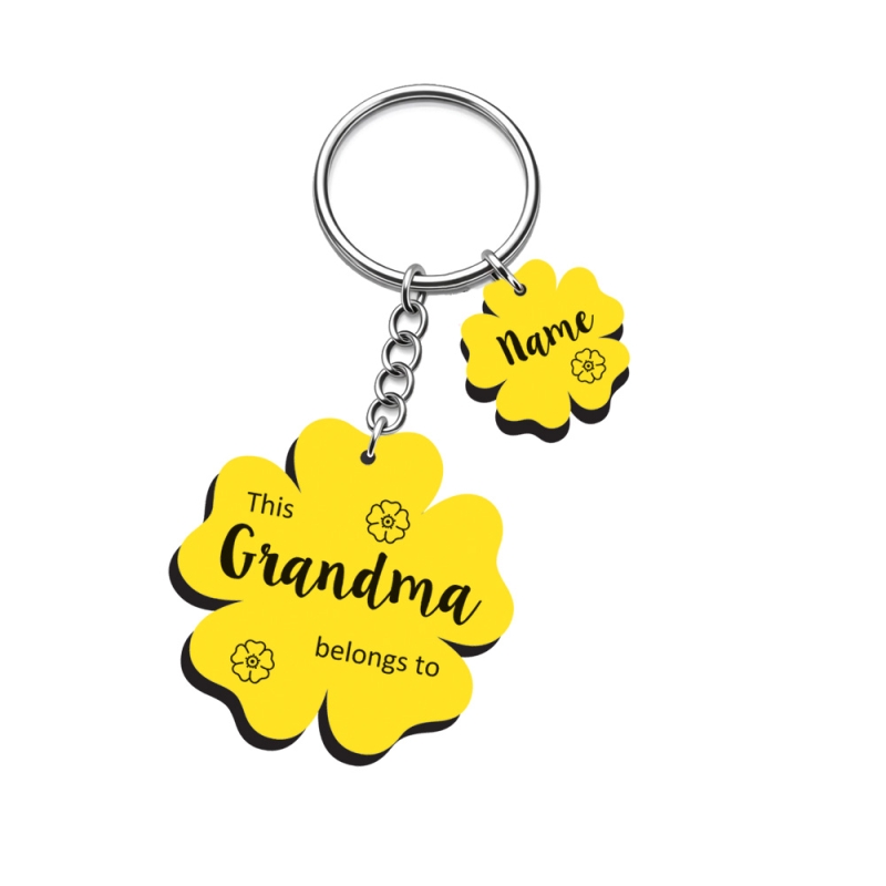 Ornate personalised flower keyring in yellow laminate with decorative floral engravings and name charms